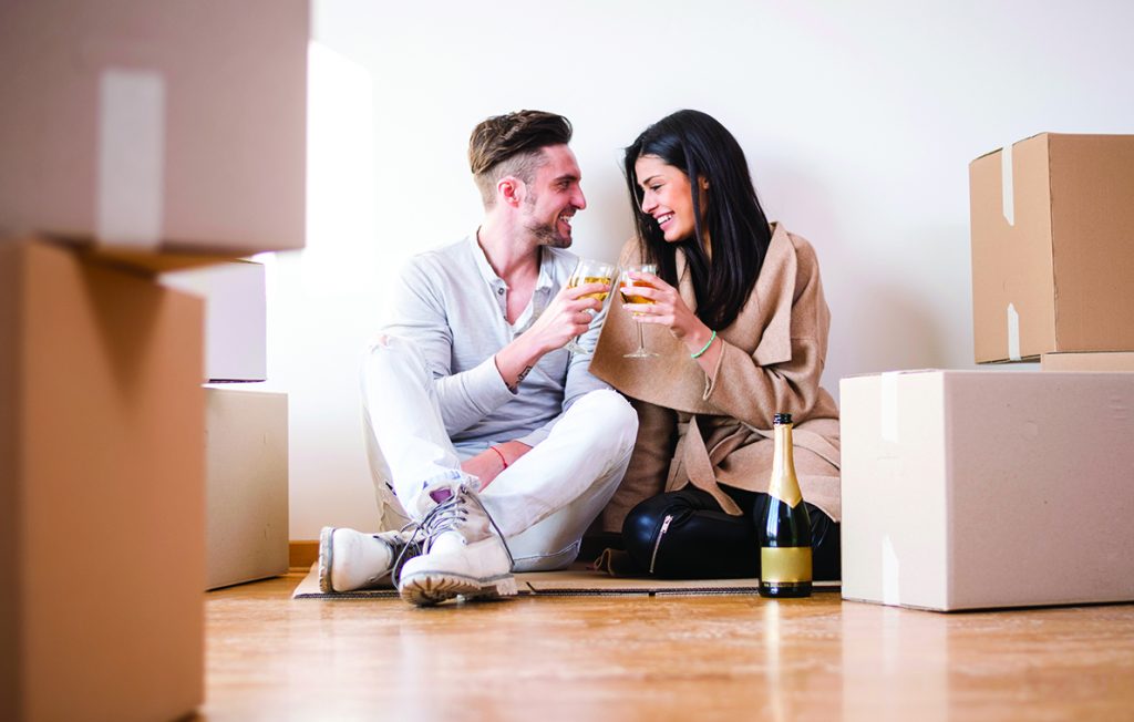 Couple having a toast in new apartment